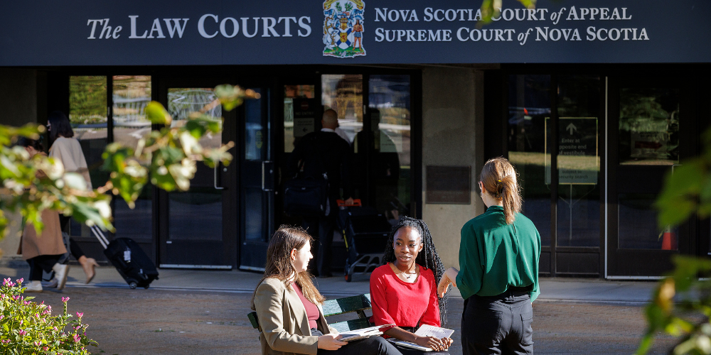 Students sit outside the NS Law Courts