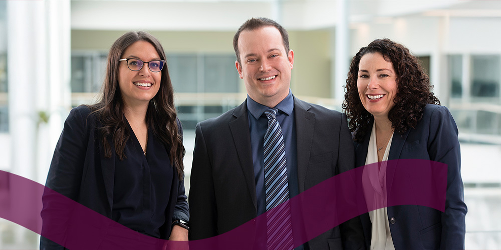 Three professionally dressed people.